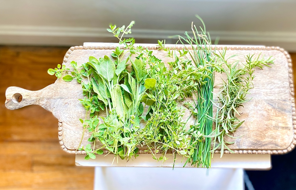 Garden Herbs cut and placed on a cutting board
